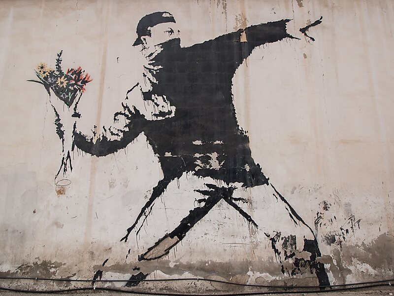 Man Throwing Flowers by Banksy in Beit Sahur | Sygic Travel